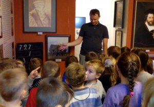 Dzieci oglądają obrazy przedstawicieli rodu Łaskich.